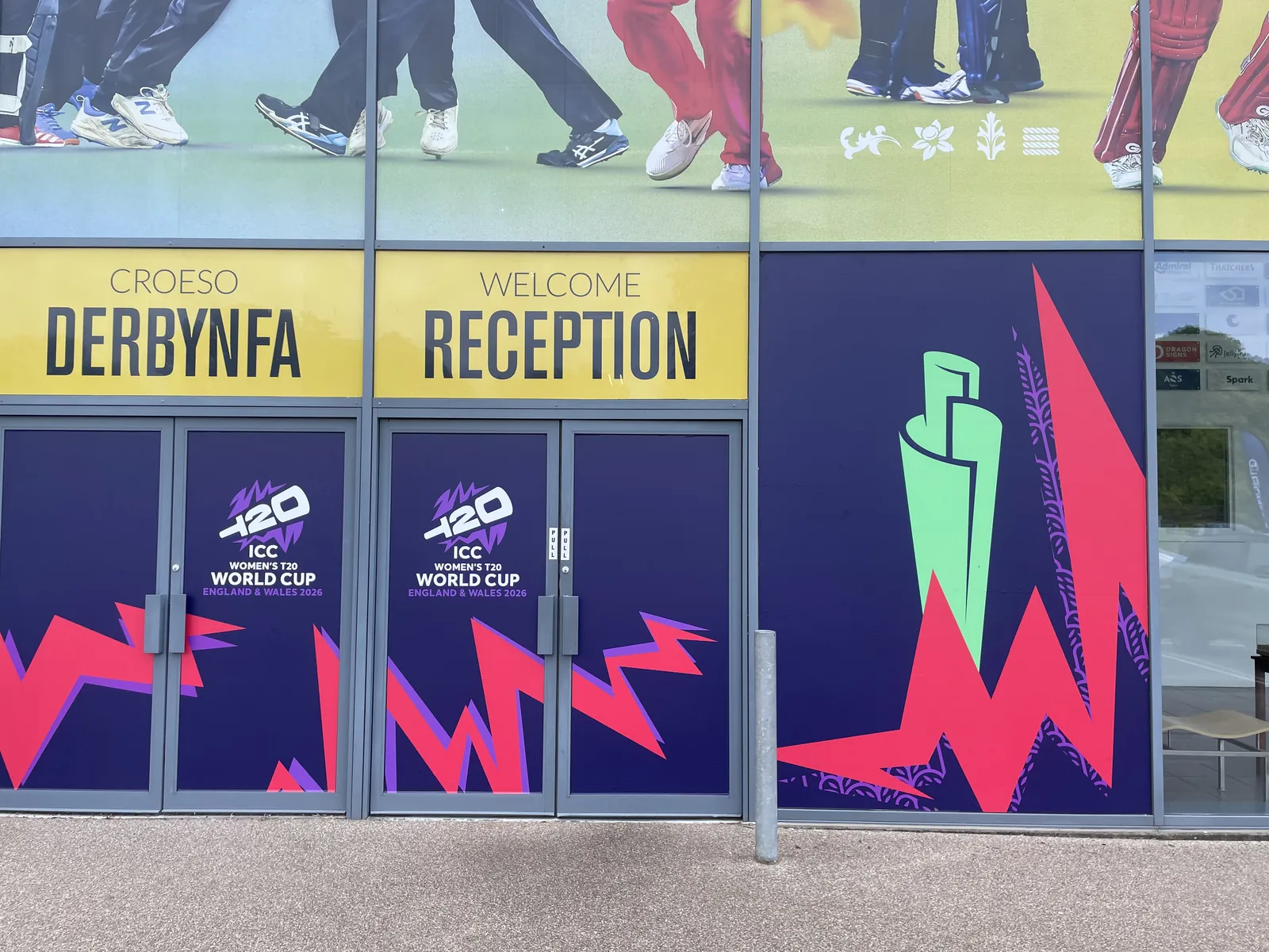 Bilingual reception fascias above doors carrying printed window graphics
