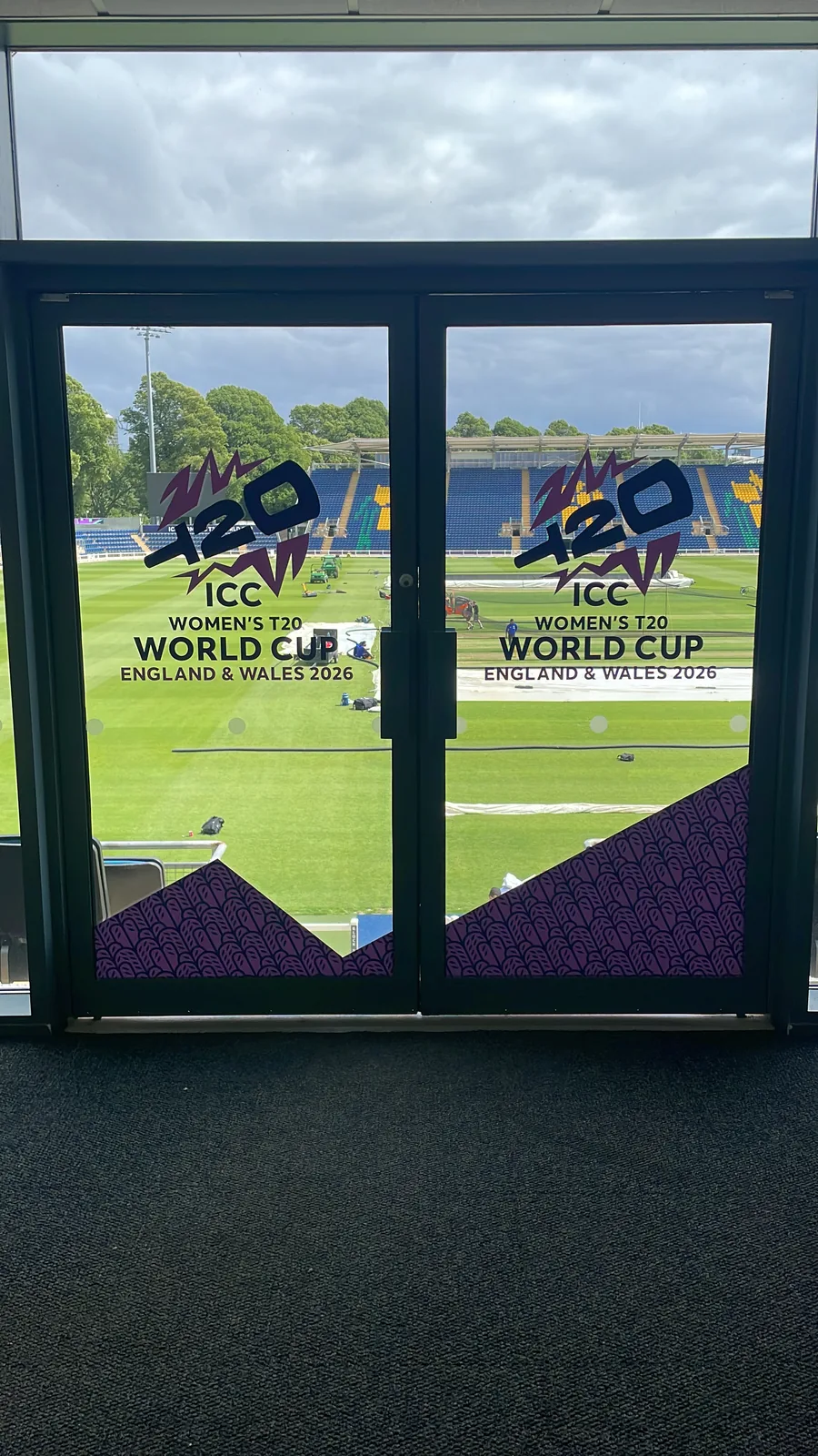 Printed window graphics on glazed stadium doors overlooking the pitch